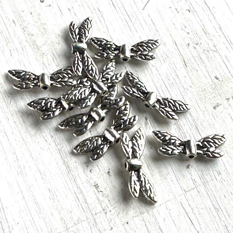 A cluster of pewter dragonfly beads