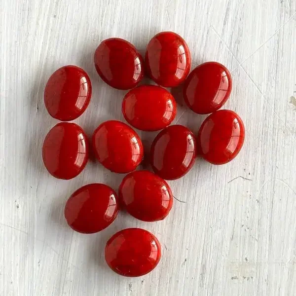 A group of red oval shaped beads