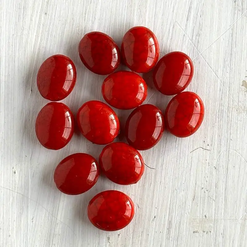 A group of red oval shaped beads