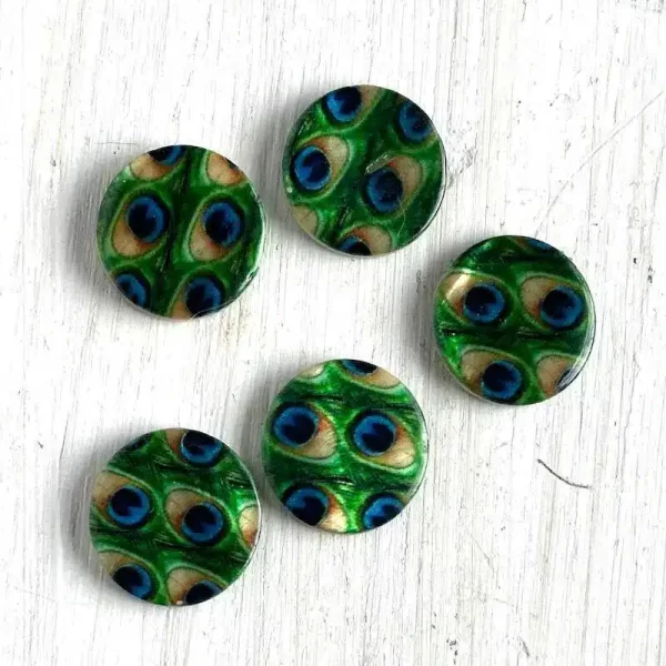 Five circular beads with paintings of peacock feathers