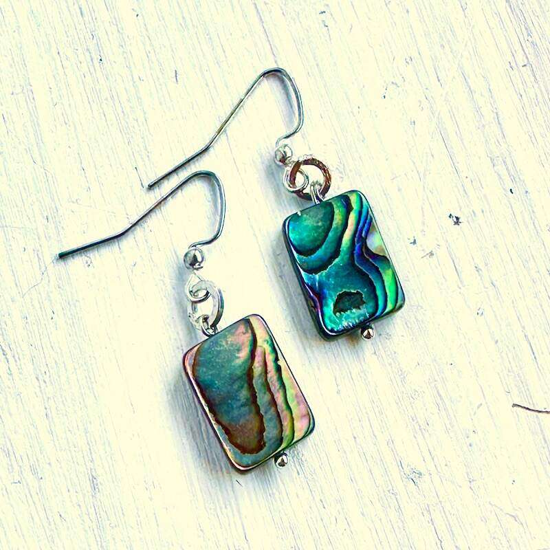 A pair of rectangular shaped abalone earrings with flashes of blue, green and magenta