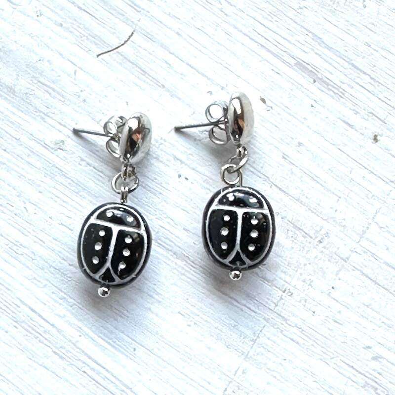 oval black agate carved into scarabs with white accents