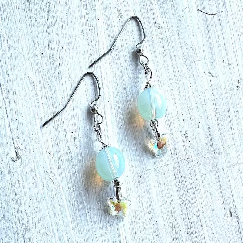 A pair of moonstone earrings with crystal stars