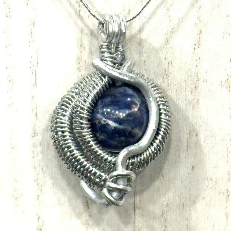 A sodalite sphere, wire wrapped